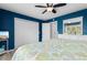 Bright bedroom with blue walls, neutral bedding, and a ceiling fan at 507-C 2Nd Ave. N, North Myrtle Beach, SC 29582