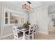 Inviting dining room with a decorative light fixture, bay window, and seating for four at 507-C 2Nd Ave. N, North Myrtle Beach, SC 29582
