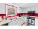 Well lit kitchen featuring white cabinets, stainless steel appliances, and a double sink at 507-C 2Nd Ave. N, North Myrtle Beach, SC 29582