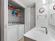 Functional laundry room with white cabinetry, sink, and laundry machines at 507-C 2Nd Ave. N, North Myrtle Beach, SC 29582