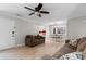 Open-concept living room showcasing hardwood floors, a modern ceiling fan and an adjacent dining area at 507-C 2Nd Ave. N, North Myrtle Beach, SC 29582