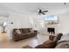 Cozy living room with a brick fireplace, large television, ceiling fan, and comfortable seating arrangement at 507-C 2Nd Ave. N, North Myrtle Beach, SC 29582