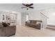 Bright living room features a ceiling fan, neutral walls, and an adjacent dining area with large windows at 507-C 2Nd Ave. N, North Myrtle Beach, SC 29582