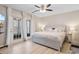 Well-lit primary bedroom with a ceiling fan, French doors to the outside, and light, bright furniture at 507-C 2Nd Ave. N, North Myrtle Beach, SC 29582