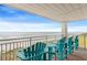 Condo balcony with beach views, blue chairs, and a serene ocean backdrop at 5800 N Ocean Blvd. # 405, North Myrtle Beach, SC 29582