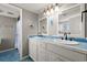 Well-lit bathroom featuring double sinks with blue tile, offering plenty of space for morning routines at 5800 N Ocean Blvd. # 405, North Myrtle Beach, SC 29582