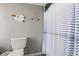 Cozy bathroom with striped shower curtain, pelican wall art, and blue tile flooring at 5800 N Ocean Blvd. # 405, North Myrtle Beach, SC 29582