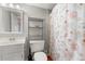 Clean bathroom with stylish cabinet, mirror and blue shower curtain at 5800 N Ocean Blvd. # 405, North Myrtle Beach, SC 29582