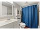 Well-lit bathroom including stylish mirror, vanity and blue shower curtain at 5800 N Ocean Blvd. # 405, North Myrtle Beach, SC 29582