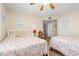 Comfortable bedroom featuring two beds, ceiling fan and carpet at 5800 N Ocean Blvd. # 405, North Myrtle Beach, SC 29582