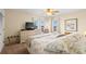 A relaxing bedroom with carpet, TV, ceiling fan and neutral tones at 5800 N Ocean Blvd. # 405, North Myrtle Beach, SC 29582