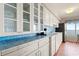 Bright kitchen with white cabinetry, blue tile backsplash, and modern appliances, offering a functional and stylish cooking area at 5800 N Ocean Blvd. # 405, North Myrtle Beach, SC 29582