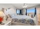 This spacious main bedroom includes a white bed frame, blue coastal accents and balcony access at 5800 N Ocean Blvd. # 405, North Myrtle Beach, SC 29582