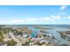 Stunning aerial view showcases a waterfront community with a marina, ocean access, and various amenities at 5840 Longwood Dr. # 303, Murrells Inlet, SC 29576