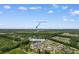 Aerial view of a residential area with trees, golf course, and Surfside Beach in the distance at 5840 Longwood Dr. # 303, Murrells Inlet, SC 29576