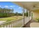 Balcony overlooking lush golf course, a perfect spot for relaxation and enjoying the view at 5840 Longwood Dr. # 303, Murrells Inlet, SC 29576