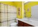 Bright bathroom with shower, toilet and vanity with wood cabinets and a large mirror at 5840 Longwood Dr. # 303, Murrells Inlet, SC 29576