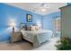 Serene bedroom with light blue walls, plush bedding, and ample natural light, creating a relaxing retreat at 5840 Longwood Dr. # 303, Murrells Inlet, SC 29576