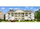 Inviting three-story condo building with multiple balconies, white railings, and exterior staircases at 5840 Longwood Dr. # 303, Murrells Inlet, SC 29576