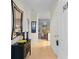 Bright hallway featuring tile flooring, decorative mirror, and artwork that leads to living area at 5840 Longwood Dr. # 303, Murrells Inlet, SC 29576