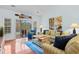 Open living room with hardwood floors, comfortable seating, stylish décor, and sliding glass doors at 5840 Longwood Dr. # 303, Murrells Inlet, SC 29576