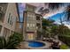 Charming backyard with a pool, outdoor seating, and spiral staircase to upper floors at 600 48Th Ave. S # 201, North Myrtle Beach, SC 29582