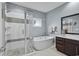 Modern bathroom with a glass-enclosed shower, soaking tub, and stylish vanity with sink at 600 48Th Ave. S # 201, North Myrtle Beach, SC 29582