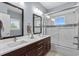 Modern bathroom with dual sinks, glass shower, modern backsplash and a large mirror at 600 48Th Ave. S # 201, North Myrtle Beach, SC 29582