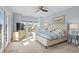 Light filled primary bedroom with water views, a seating area and a ceiling fan at 600 48Th Ave. S # 201, North Myrtle Beach, SC 29582