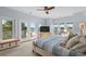 Light filled primary bedroom with water views, french doors, seating area and a ceiling fan at 600 48Th Ave. S # 201, North Myrtle Beach, SC 29582