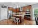 A modern kitchen with wood cabinets, stainless steel appliances, granite countertops, and an island with barstool seating at 600 48Th Ave. S # 201, North Myrtle Beach, SC 29582