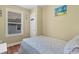 Simple bedroom with a single bed, window, and door to storage at 6001 South Kings Hwy., Myrtle Beach, SC 29575