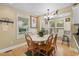 Cozy dining area with a round table, surrounded by windows offering natural light and pleasant neighborhood views at 6001 South Kings Hwy., Myrtle Beach, SC 29575