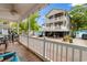 Relaxing covered porch view of beach home on stilts featuring upper and lower decks at 6001 South Kings Hwy., Myrtle Beach, SC 29575