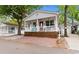 Charming cottage featuring a welcoming front porch and a brick paved parking area, perfect for guests at 6001 South Kings Hwy., Myrtle Beach, SC 29575