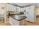 Well-lit kitchen boasts a peninsula island with a breakfast bar, complemented by white cabinetry and modern appliances at 6001 South Kings Hwy., Myrtle Beach, SC 29575