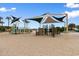 Inviting playground area with climbing structures and shaded canopies on a sandy base near the beach at 6001 South Kings Hwy., Myrtle Beach, SC 29575
