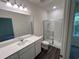 Modern bathroom featuring quartz counters, a large mirror, and a glass-enclosed shower at 630 Muster Field Ct., Conway, SC 29526