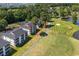 Aerial view of the condo complex with golf course frontage and nearby pond at 650 River Oaks Dr. # 46I, Myrtle Beach, SC 29579