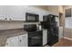The kitchen features granite countertops, black appliances, and white cabinets at 650 River Oaks Dr. # 46I, Myrtle Beach, SC 29579