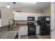 Well-equipped kitchen with granite countertops, black appliances, and ample cabinet space at 650 River Oaks Dr. # 46I, Myrtle Beach, SC 29579