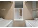 Well-lit laundry room featuring a window, shelving, and washer/dryer hookups at 650 River Oaks Dr. # 46I, Myrtle Beach, SC 29579