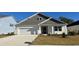 Charming single-Gathering home with a two-car garage, landscaped yard, and covered front porch at 7128 Shooting Star Way, Myrtle Beach, SC 29579