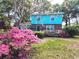 Attractive two-story home with beautiful flowers in the front yard, enhancing its curb appeal at 715 9Th Ave. S, Surfside Beach, SC 29575