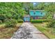 Charming two-story home with blue siding, brick accents, and a well-maintained front yard at 715 9Th Ave. S, Surfside Beach, SC 29575