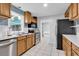 Updated kitchen features stainless appliances, white countertops, tile backsplash and ample cabinetry at 715 9Th Ave. S, Surfside Beach, SC 29575