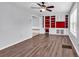 Living room featuring wood-look flooring, a ceiling fan, and a built-in bookcase at 715 9Th Ave. S, Surfside Beach, SC 29575