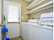 Efficient laundry room with washer, dryer, and storage shelves at 755 Burcale Rd. # D6, Myrtle Beach, SC 29579