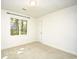 Bedroom with neutral carpet, white walls, and a window overlooking the trees at 816 Kittiwake Ln., Murrells Inlet, SC 29576