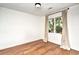 Bright bedroom with hardwood floors, neutral walls, and a window overlooking trees at 816 Kittiwake Ln., Murrells Inlet, SC 29576